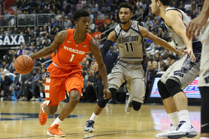 Frank Howard drives to the basket past two Georgetown defenders in SU's road loss on Saturday.